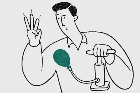 waist-up view of a man with a neat side parting inflating a small balloon with a bicycle pump while counting the breaths on his fingers; proud but slightly confused