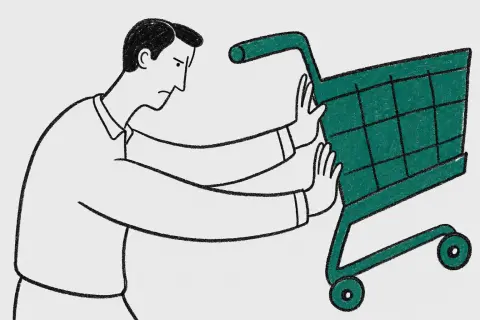 waist-up view of a man with a neat side parting trying to push a giant stubborn shopping cart up invisible stairs; determined